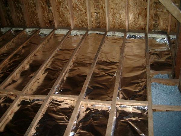 IMGP1103.JPG - Radiant foil barrier installed on top of batts.  There will be approximately 3/4" gap between the foil and the subfloor.  Tubes for the radiant hydronic heat in gypcrete will installed on top of the subfloor